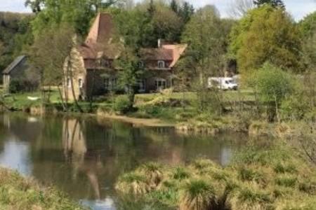 une maison à côté d'une rivière avec une maison dans l'établissement le vieux logis, à Le PARC