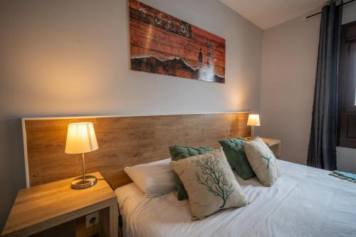 a bedroom with a bed with a wooden headboard at Apartamento con Encanto Baqueira 1500 in Naut Aran