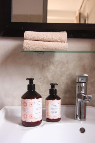 two bottles of soap sitting on a bathroom sink at Villa Quince in Ouirgane