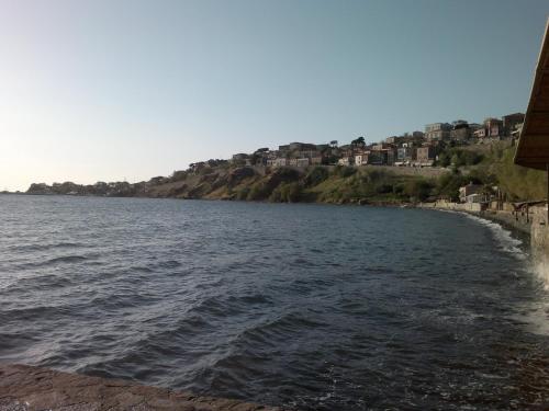 a view of a body of water with houses at Olive Press Hotel in Mithymna