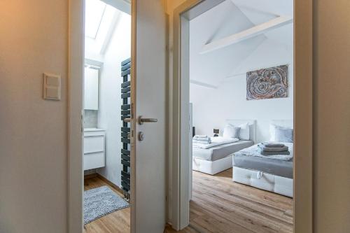pokój z sypialnią z łóżkiem i lustrem w obiekcie AusZeit Steiraland 2 mit privaten Terrasse und Garten und Parkplatz w mieście Nennersdorf