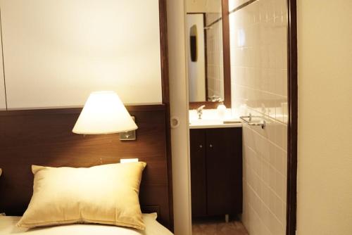 - une chambre avec un lit doté d'une lampe et d'un lavabo dans l'établissement Charming comfortable studio, heart of Vauban 533, à Lille