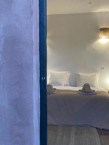 a bedroom with a bed with hats on it at Villa Quince in Ouirgane