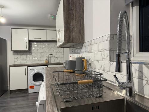 a kitchen with a dish drying rack on the counter at Elegance meets Comfort Free Parking Wifi Netflix and Ensuite Bathrooms in Birmingham