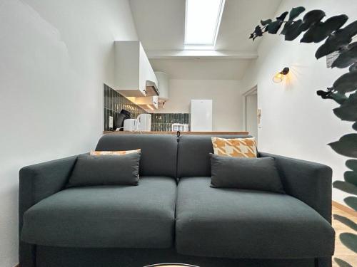 un salon avec un canapé bleu dans une pièce dans l'établissement Belin Cool terrasse et parking proche centre ville, à Reims