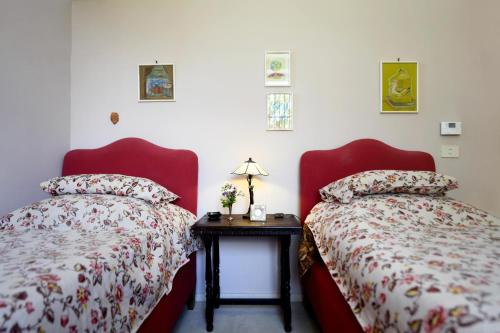 two beds sitting next to each other in a room at Colonna Country Home in Ururi