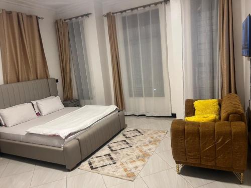 a living room with a bed and a couch and a chair at SwabZ in Kira