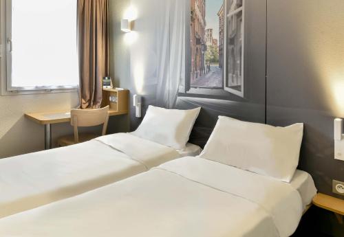 Postel nebo postele na pokoji v ubytování B&B HOTEL Toulouse Cité de l'Espace Mouchotte