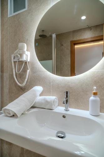 a bathroom with a sink and a mirror at HolidaysBCN Rooms in Barcelona