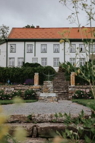 a large white building with a red roof at Hoel Gård - Herregården ved Mjøsa in Nes i Ådal