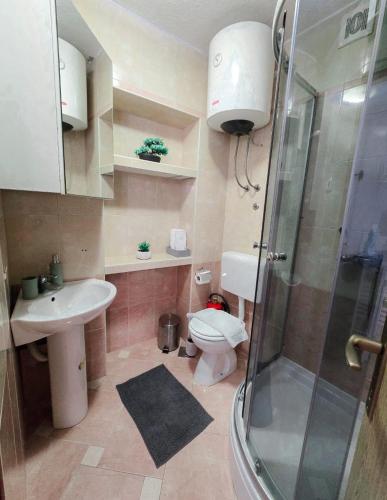 a bathroom with a toilet and a sink and a shower at Private bedroom with bathroom in Baška Voda