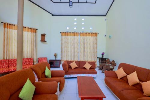 a living room with couches and a table at Limeshine Residence - Airport Transit Hotel in Katunayake