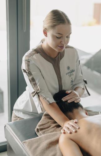 a woman getting her hair cut in a salon at Lindos Grand Resort & Spa - Adults Only in Líndos