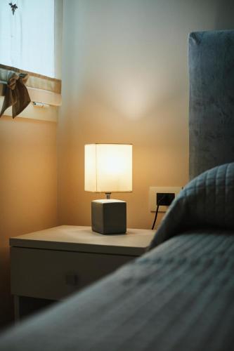 a lamp sitting on a dresser next to a bed at Agriturismo Zapparè Farm Hotel in Trevignano