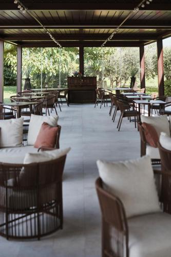 a group of tables and chairs in a patio with tables at Agriturismo Zapparè Farm Hotel in Trevignano
