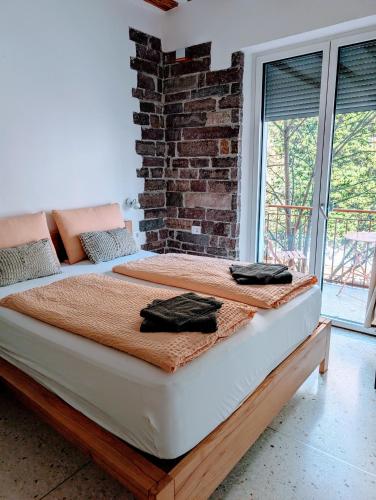 a bed in a room with a brick wall at Gardar in Bolzano