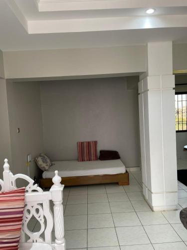 a bedroom with a bed in a room at Creek Heights Apartment in Mombasa