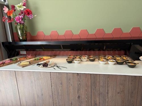 a table with a bunch of food on it at Landgoed ISVW in Leusden