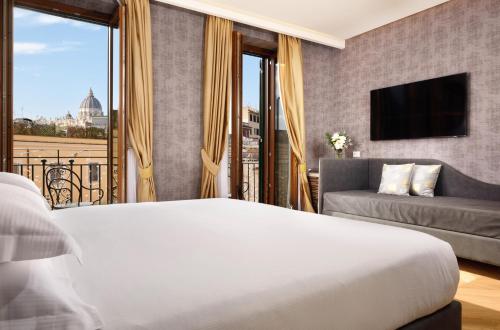 a hotel room with a bed and a couch at Atlante Star Hotel in Rome