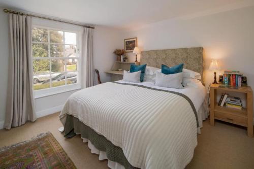 a bedroom with a large bed and a window at Lily Cottage in Gurnard