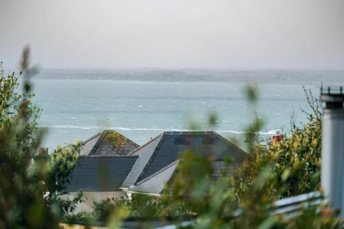 a view of a body of water with a house at Lily Cottage in Gurnard