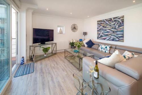 a living room with a couch and a television at Saltwater apartment in Cowes