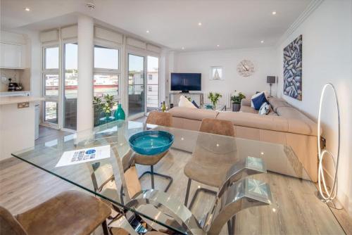 a living room with a glass table and a couch at Saltwater apartment in Cowes