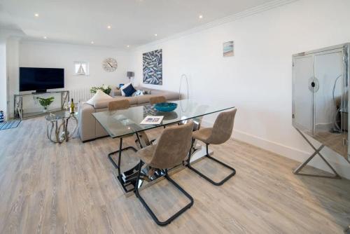 a living room with a glass table and a couch at Saltwater apartment in Cowes