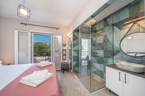 a bathroom with a large shower and a sink at Sami Diamond Apartments in Sami