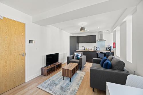 a living room with a couch and a table at Alexandra House by Guestz in Stockport