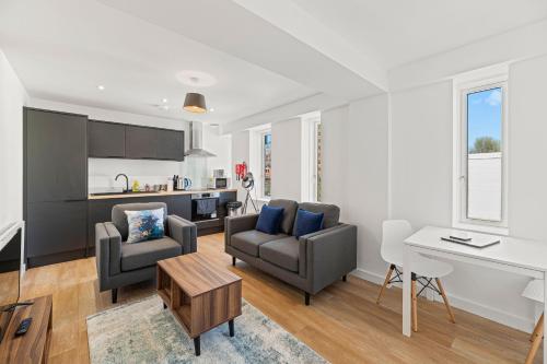 a living room with a couch and a table at Alexandra House by Guestz in Stockport
