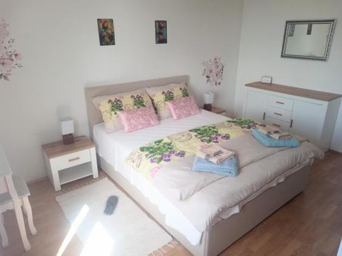 a bedroom with a bed with two towels on it at Apartman Petra in Senj