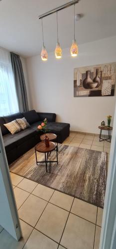 a living room with a black couch and a table at Zum Brückentor in Mayen