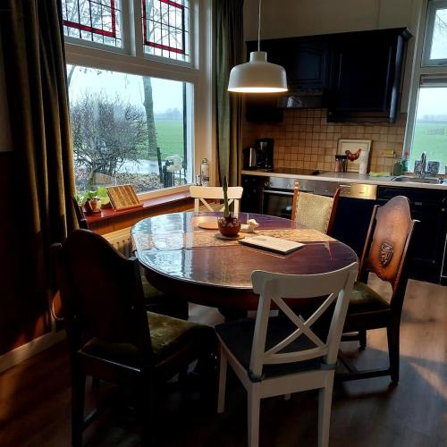 a dining room table and chairs in a kitchen at De Mast bij Fort Vechten on the countryside & close to Utrecht in Bunnik