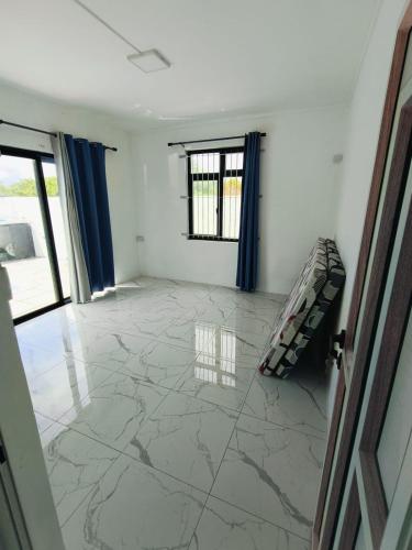 a living room with a large marble floor at Yuvehdha Villa in Union Maurel