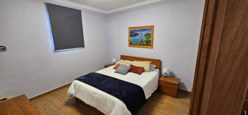 a bedroom with a bed with pillows on it at Santa Barbara Beach hotspot in Ribeira Grande