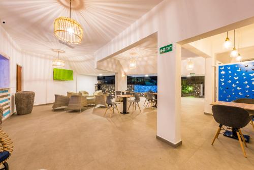 a lobby with chairs and tables in a building at Azur Paradise Hotel & Rooftop Bar in Grand Baie