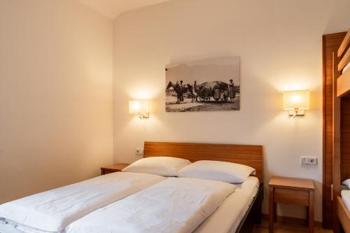 a bedroom with a bed and a painting on the wall at St. Ulrichhof in Lana