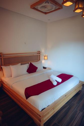 a bedroom with a large bed with two towels on it at Kesar Palace Hotel & Restaurant, Skardu in Skardu