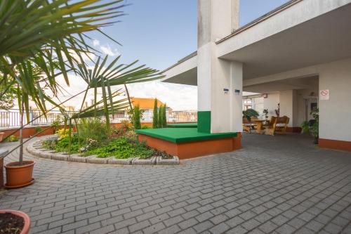 a green bench on the side of a building at Rooftop City Residence with Underground Parking in Budapest