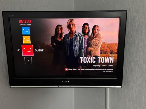 a television screen with a movie town on it at Harbour View Apartment Wick in Wick