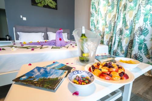 a table with a bottle of wine and a bowl of fruit at La Casa Sorento in Victoria