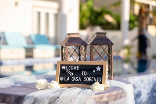 a table with two lanterns and a sign on it at La Casa Sorento in Victoria