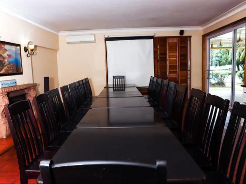 a conference room with a long table and chairs at The Star Guest House in Witbank