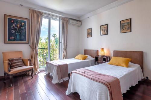 Postel nebo postele na pokoji v ubytování Villa Roxane