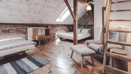 a bedroom with two bunk beds and a ladder at Zapomnienie in Nowa Ruda