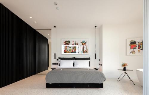 a bedroom with a bed and a white wall at MAP Boutique Hotel in Nicosia
