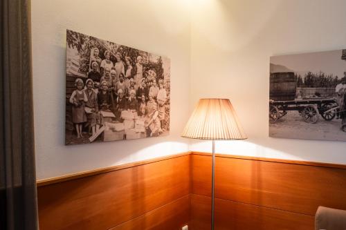 a room with two pictures on the wall and a lamp at St. Ulrichhof in Lana