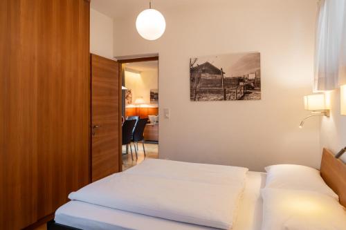 a hotel room with a bed and a mirror at St. Ulrichhof in Lana