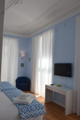 a bedroom with a bed and a tv on a wall at Dream Chiado Apartments in Lisbon